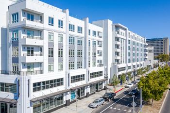 a large white building with a street in front of it